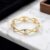 ⁦اسورة فاخرة باللون الذهبي الأنيق، يزينها أشكال قلوب باللون الفضي اللامع، بتصميم مموج ونقوش رقيقة. أناقة ورومانسية تخطف الأنظار علي معصمكِ.⁩ - الصورة ⁦4⁩